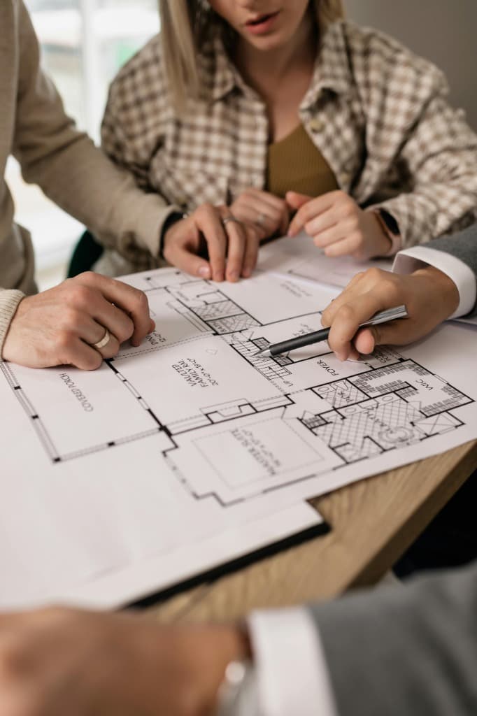 Homeowners reviewing floor plans